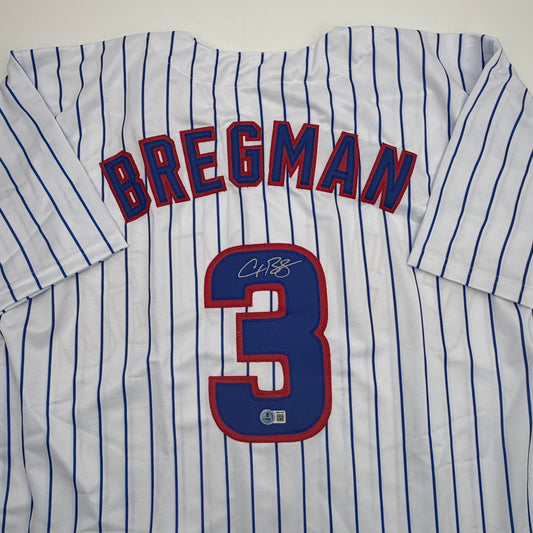 White pinstriped baseball jersey with "BREGMAN" and number 3 displayed, showing autographed signature on navy number patch.