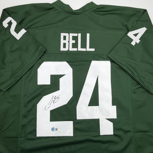 Back view of green Michigan State football jersey number 24 with "BELL" nameplate and autographed signature.