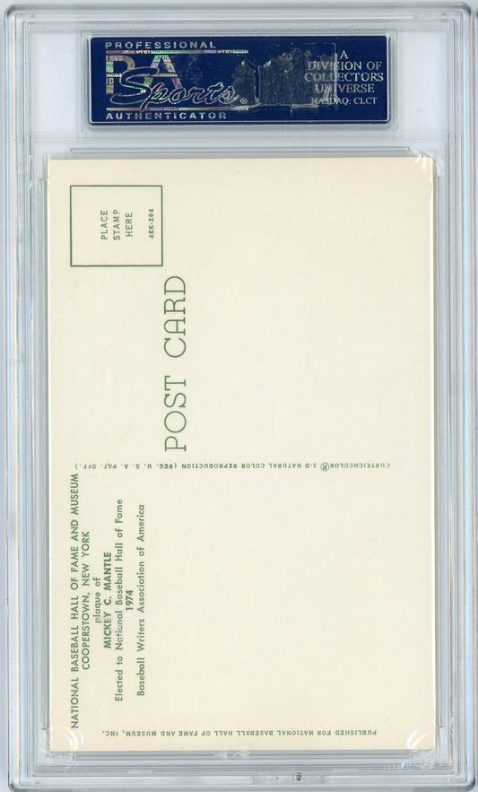 Reverse side of postcard showing blank cream-colored back with green printed text and stamp box, encased in clear PSA/DNA graded holder.