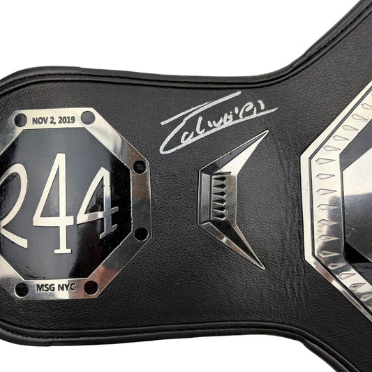 Close-up of black leather UFC championship belt with number 244, date NOV 2 2019, MSG NYC location plate, and white signature across the center.