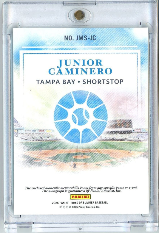 Back of baseball card in clear plastic case showing Junior Caminero Tampa Bay Shortstop with blue baseball stadium graphic and Panini branding.