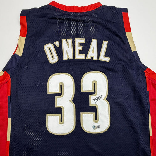 Back view of navy mesh basketball jersey with red and gold side panels, displaying "O'NEAL" and number "33" in white and gold lettering.