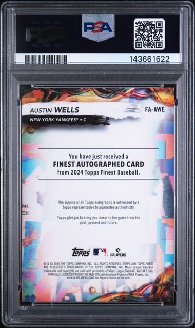 Back of graded PSA 10 baseball card showing Austin Wells autograph authentication text with colorful flame design and barcode.