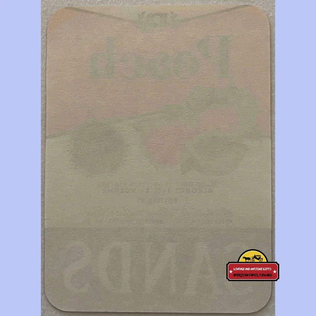 Worn beige paper with faded text and logo on Rare Antique Vintage Sands Peach Wine Label