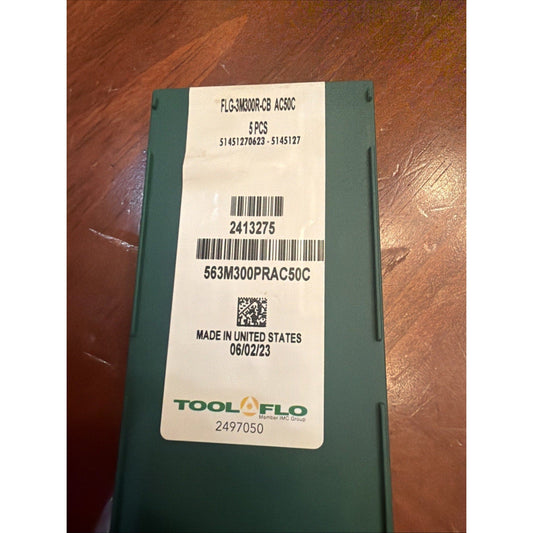 Green cardboard box with white label showing product code FLG-3M300R-CB AC50C, barcode, and Tool Flo branding on wooden surface.