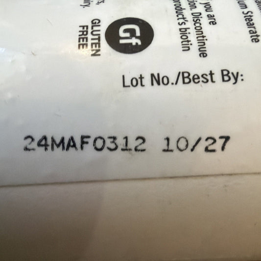 Close-up of white product label showing "GF" gluten-free symbol, lot number "24MAF0312" and best by date "10/27".