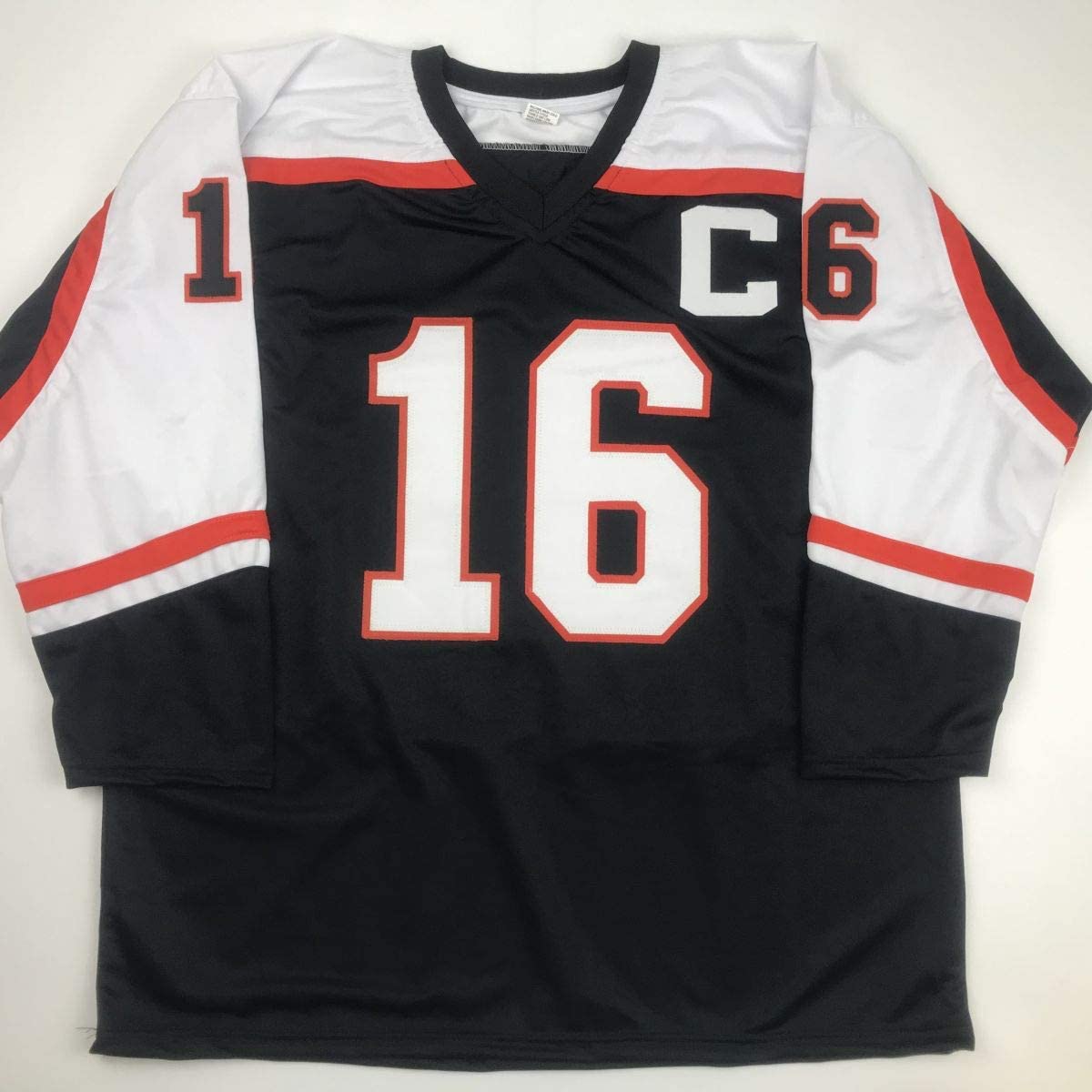 Black, red, and white hockey jersey displayed flat showing front with white number 16 and "C" captain patch.