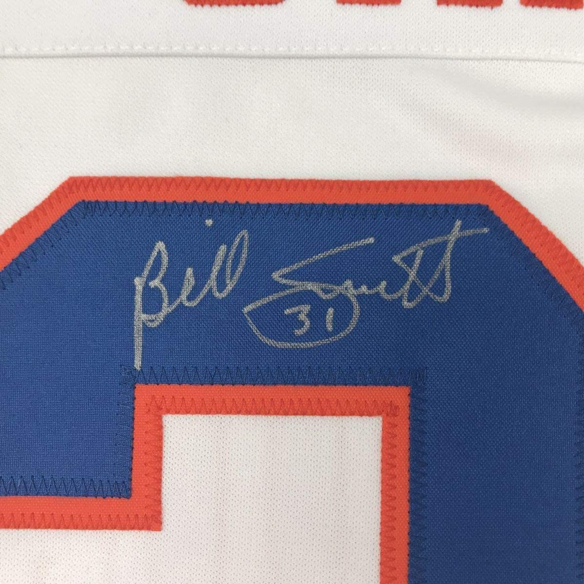 Close-up of autograph on blue jersey panel with red and white trim, showing signed name and number 31.