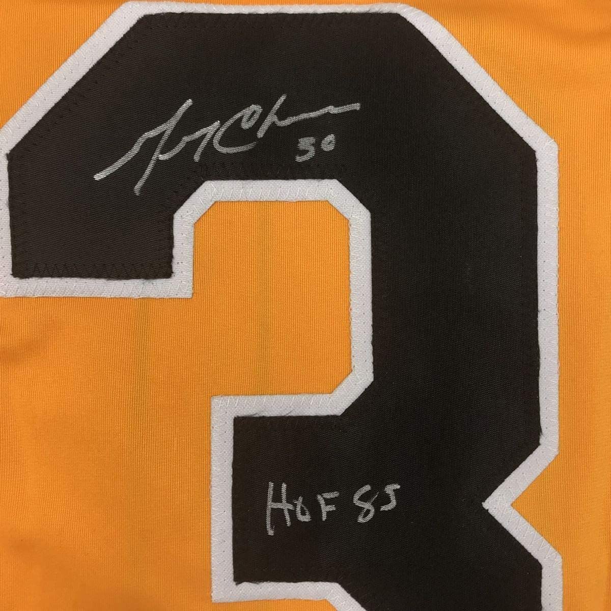Close-up of autographed black number 30 on orange jersey with "HOF 85" inscription below signature.