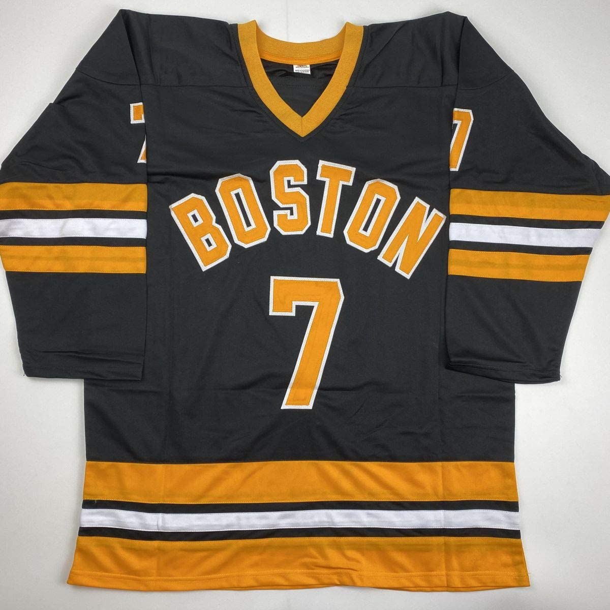 Black and gold Boston hockey jersey number 7 displayed flat against white background, showing front with "BOSTON" text and sleeve stripes.