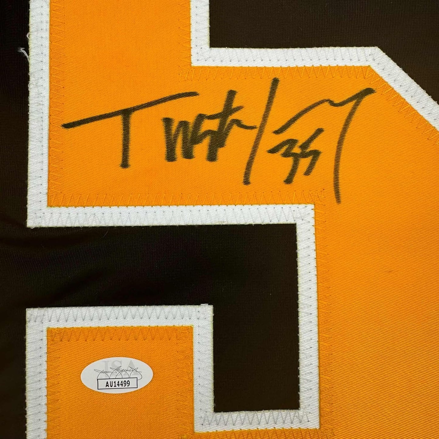 Close-up of handwritten signature on orange and black hockey jersey with white trim and JSA authentication sticker.