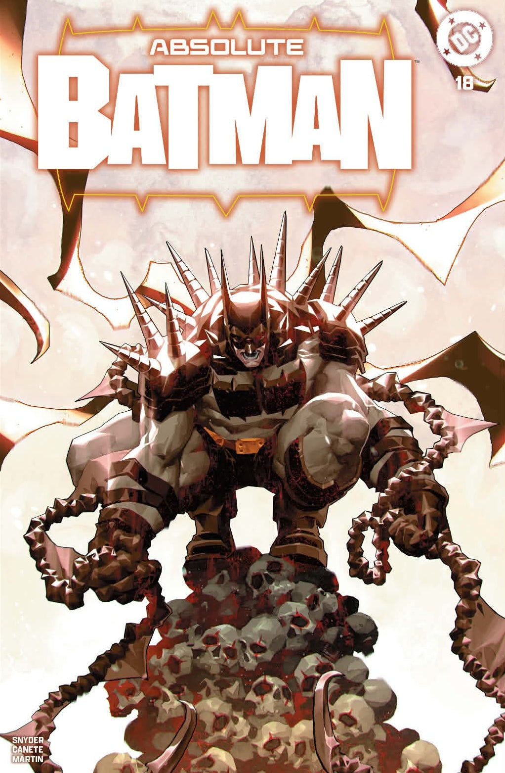 Front cover: a spiked, bronze-armored Batman stands atop pale skulls against a cream sky, with printed title and issue 18.