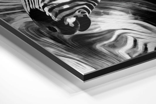 Close-up angled view of black and white marbled zebra brushed aluminum Dibond wall art with black border edge visible.