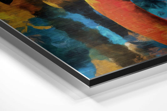 Close-up angled view of layered metal backing and black border edge of colorful abstract brushed aluminum wall art print with teal, blue, orange, and yellow tones.