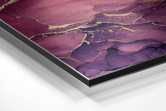 Angled view of purple, pink, and gold marble-patterned aluminium Dibond wall art with black and silver layered frame edges visible.