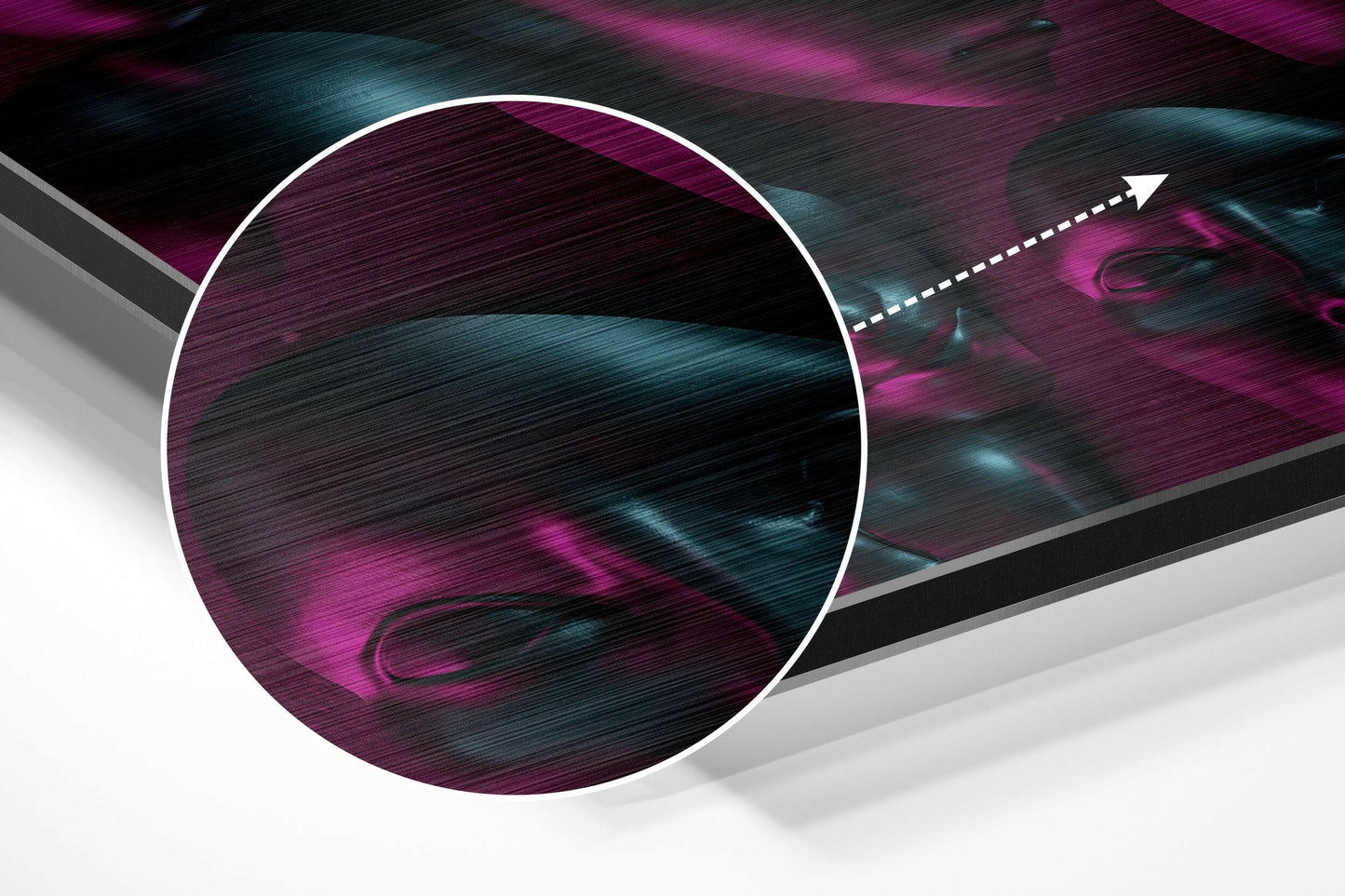 Angled perspective view of circular brushed aluminium wall art featuring magenta and teal streaked texture with white border and directional arrow.