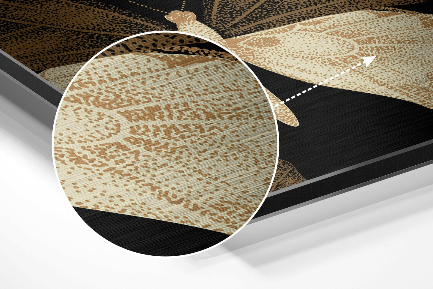 Close-up magnified view of brushed aluminium surface showing tan and cream butterfly pattern with fine horizontal texture details.