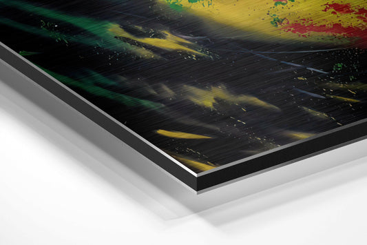 Close-up angled view of brushed aluminum dibond wall art showing teal, yellow, and red paint splashes on black background with metallic edge detail.