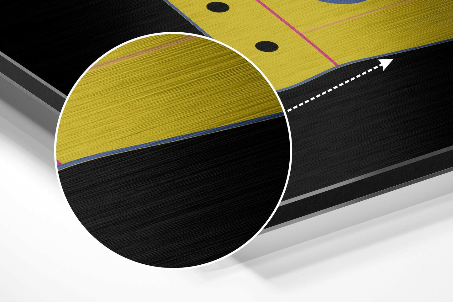 Close-up angled view of brushed aluminium wall art showing yellow and black divided circle design with blue and pink accent lines.