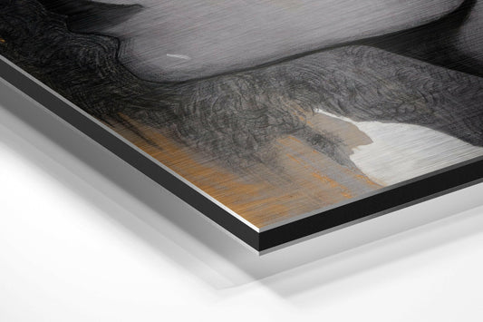 Close-up angled view of framed wall art showing woman's profile with white flower, gold brushed aluminum, and black border on white background.