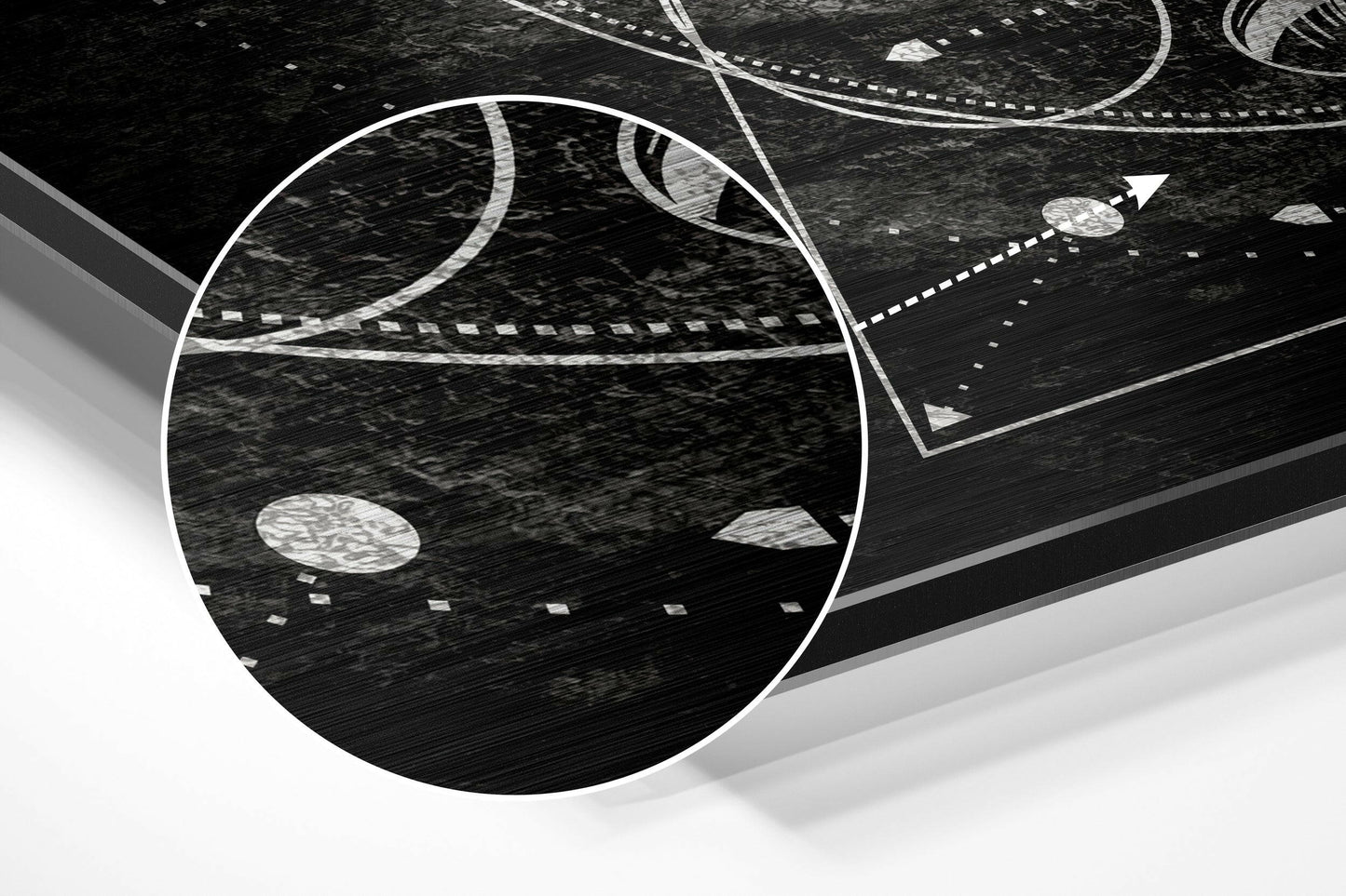 Angled perspective view of brushed aluminium wall art featuring white curved lines and geometric shapes on textured black surface.