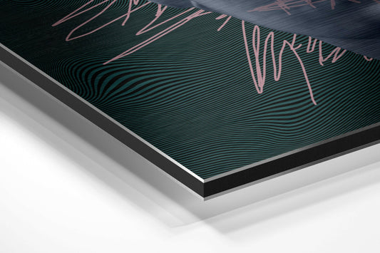 Angled close-up of brushed aluminum dibond wall art showing teal wavy lines with pink handwritten text overlay.