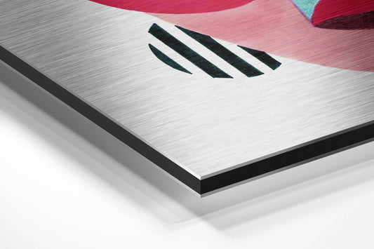Close-up angled view of brushed aluminum wall art with three black diagonal slashes and colorful abstract shapes in pink and teal at top edge.