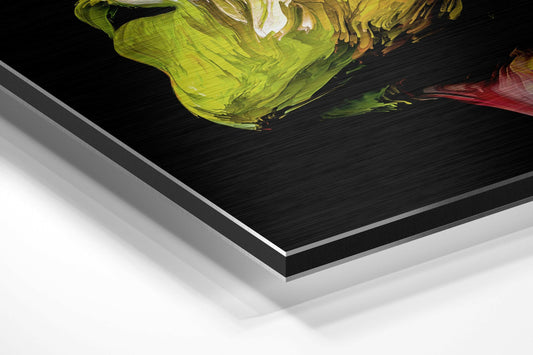 Angled perspective shot of brushed aluminium dibond panel displaying vibrant yellow and magenta abstract brushstrokes on black background.