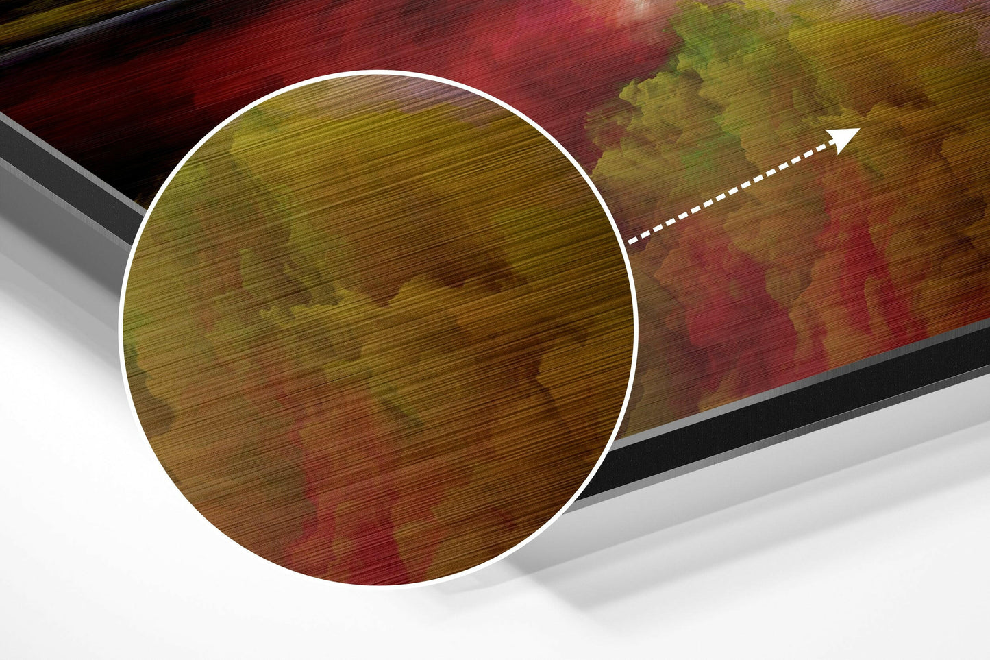 Close-up angled view of brushed aluminum wall art with red, green, and gold color clouds and white circular highlight detail.