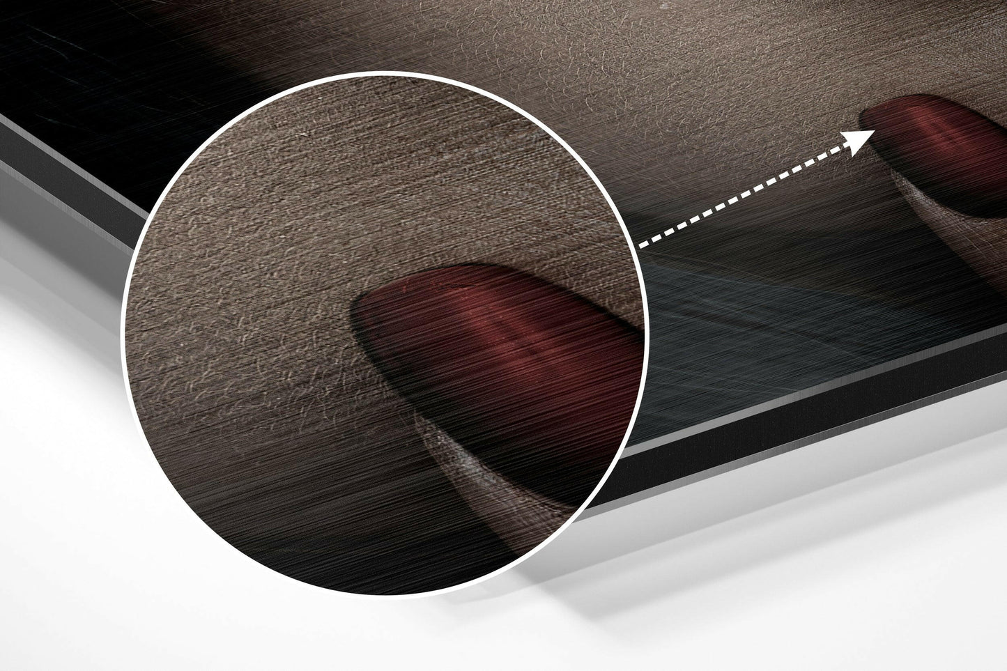 Close-up detail view of brushed aluminum surface with dark burgundy circular abstract shape and directional arrow overlay.
