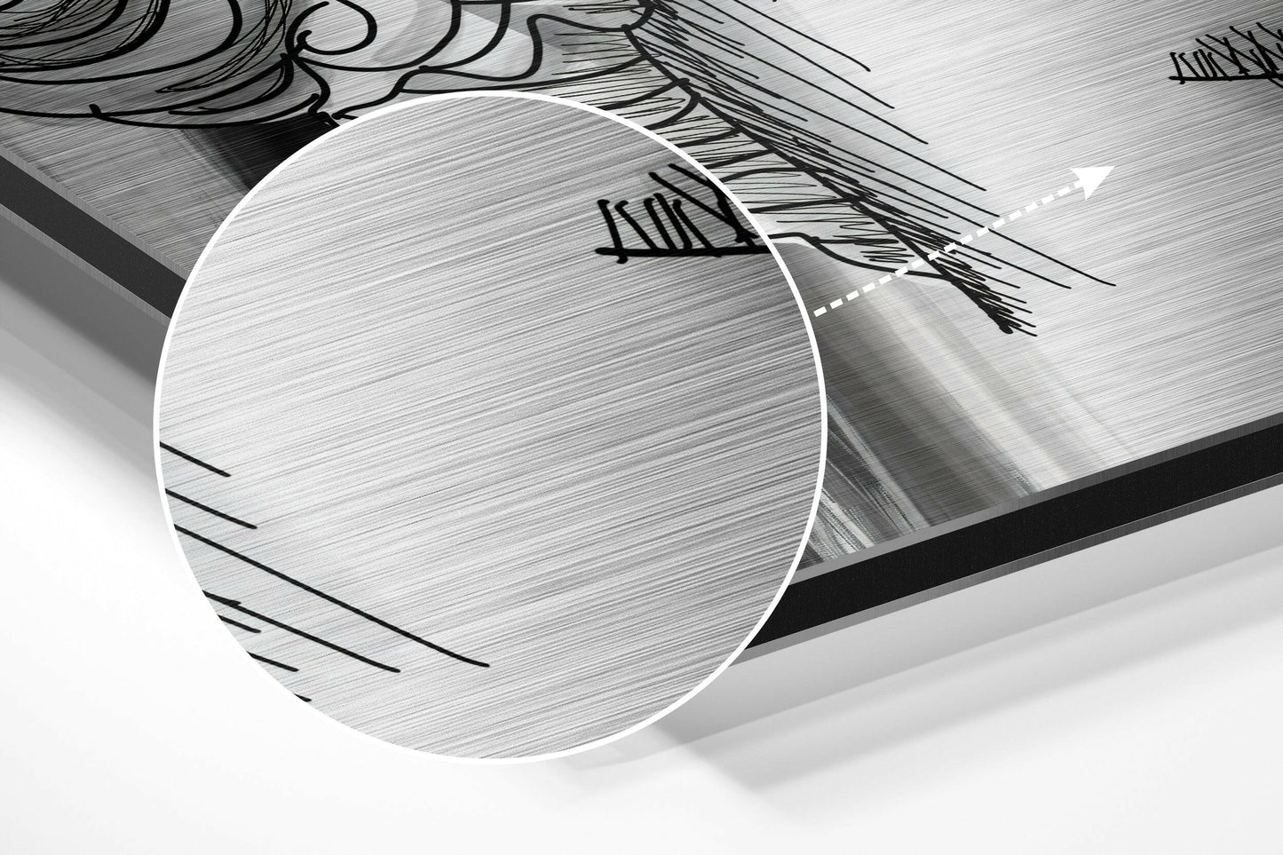 Close-up angled view of brushed aluminium Dibond sheet showing metallic surface texture with black artistic line drawings and white circular design element.