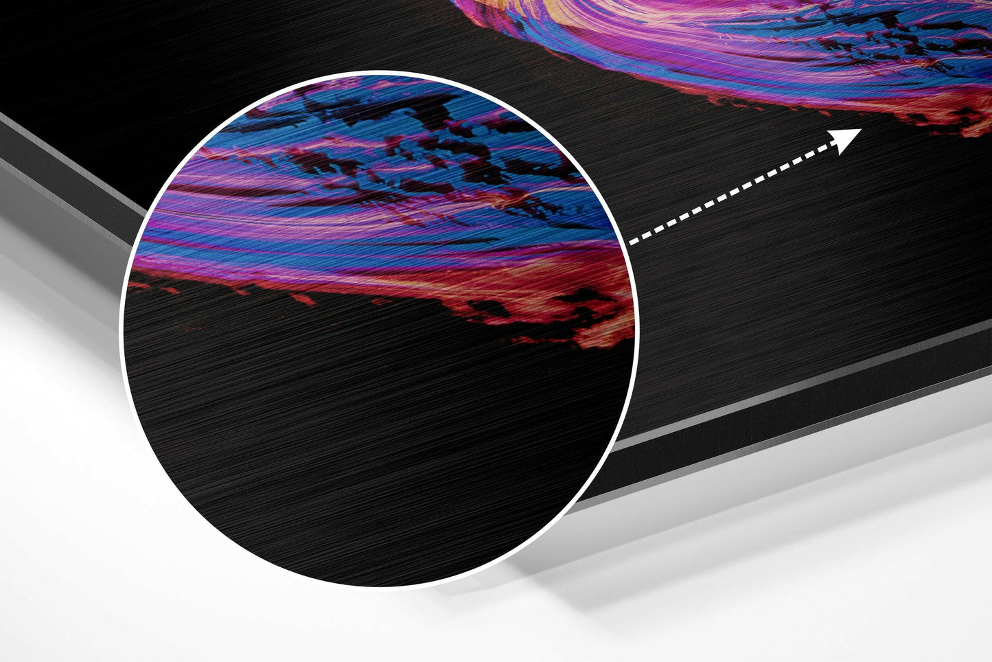 Close-up detail shot of brushed aluminum surface with vibrant pink, purple, and blue swirled patterns against black background.