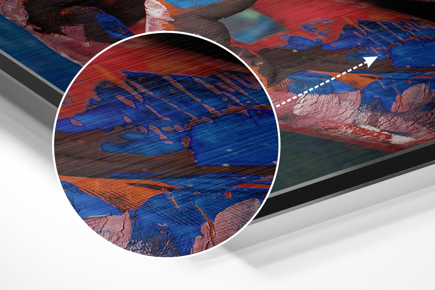 Close-up detail of brushed aluminium wall art showing blue, red, and orange abstract brushstrokes with textured surface finish.
