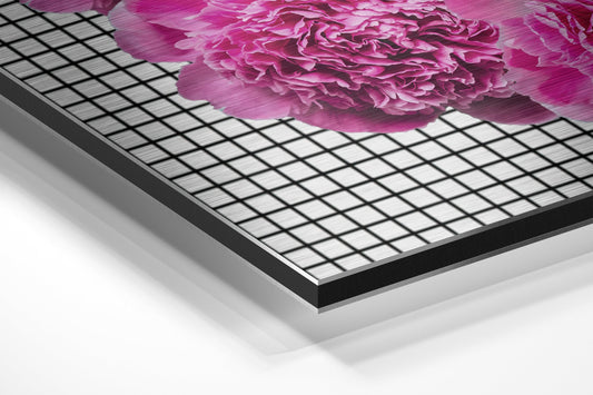 Angled perspective view of brushed aluminum dibond panel displaying vibrant pink carnation flower against grid pattern background.