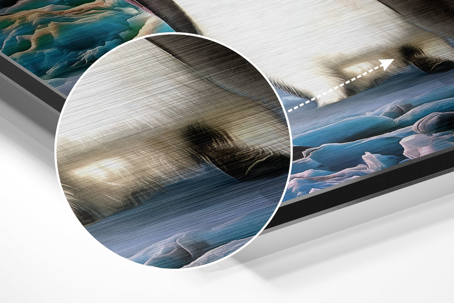 Close-up detail of brushed aluminium surface showing penguin artwork with blue water and white ice textures visible through magnified circular lens.