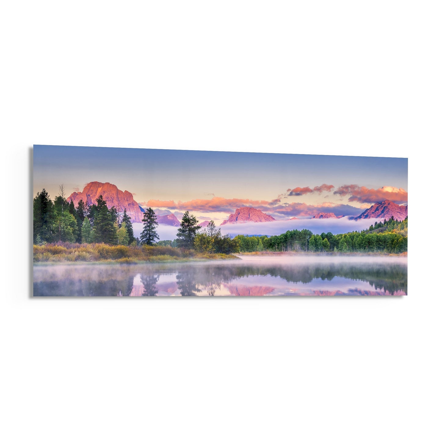 Panoramic glass wall art showing a misty river valley at sunrise with pink-lit mountains, evergreen forest, and perfect water reflections.