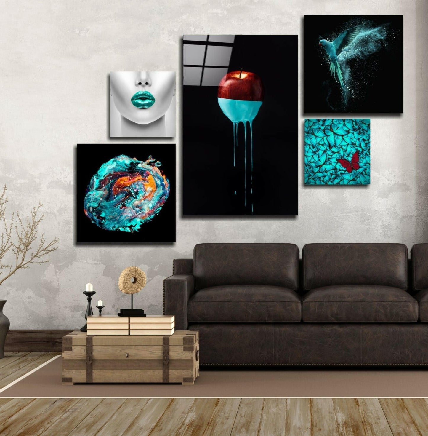 Modern living room interior with dark sofa and gallery wall displaying five turquoise and black abstract glass artworks above.