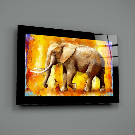 Modern glass wall art mounted on gray wall displaying an elephant in warm orange and yellow abstract oil painting style with black frame borders.