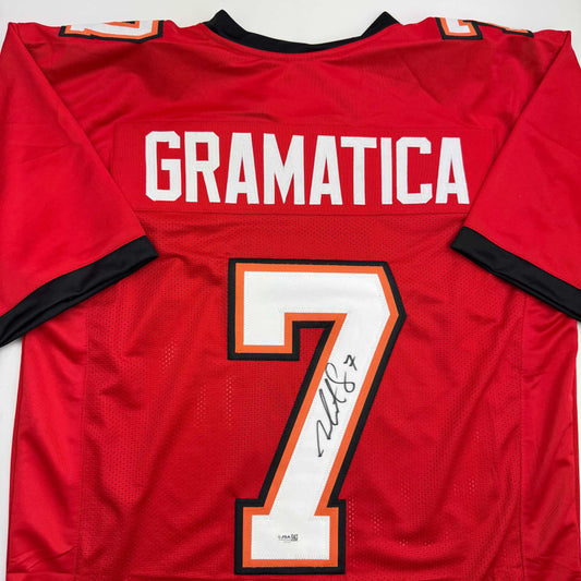 Red Tampa Bay football jersey with "GRAMATICA" and signed number 7 displayed flat against white background.