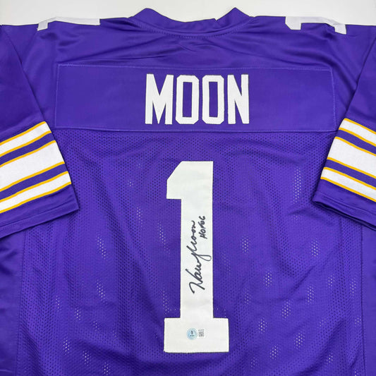 Back view of purple Minnesota Vikings jersey number 1 with "MOON" nameplate and autographed inscription across the chest.