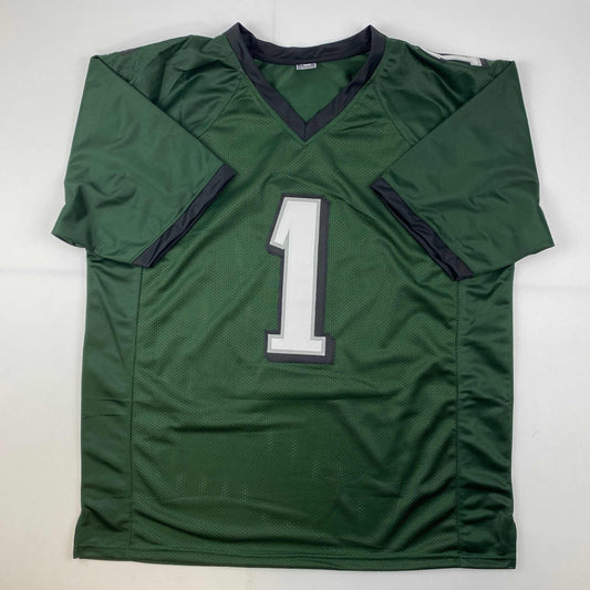 Green football jersey with white number 1 and black trim displayed flat against white background.