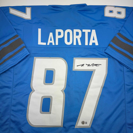 Blue Detroit Lions jersey displaying "LAPORTA" nameplate and number 87 with autograph, laid flat showing front view.
