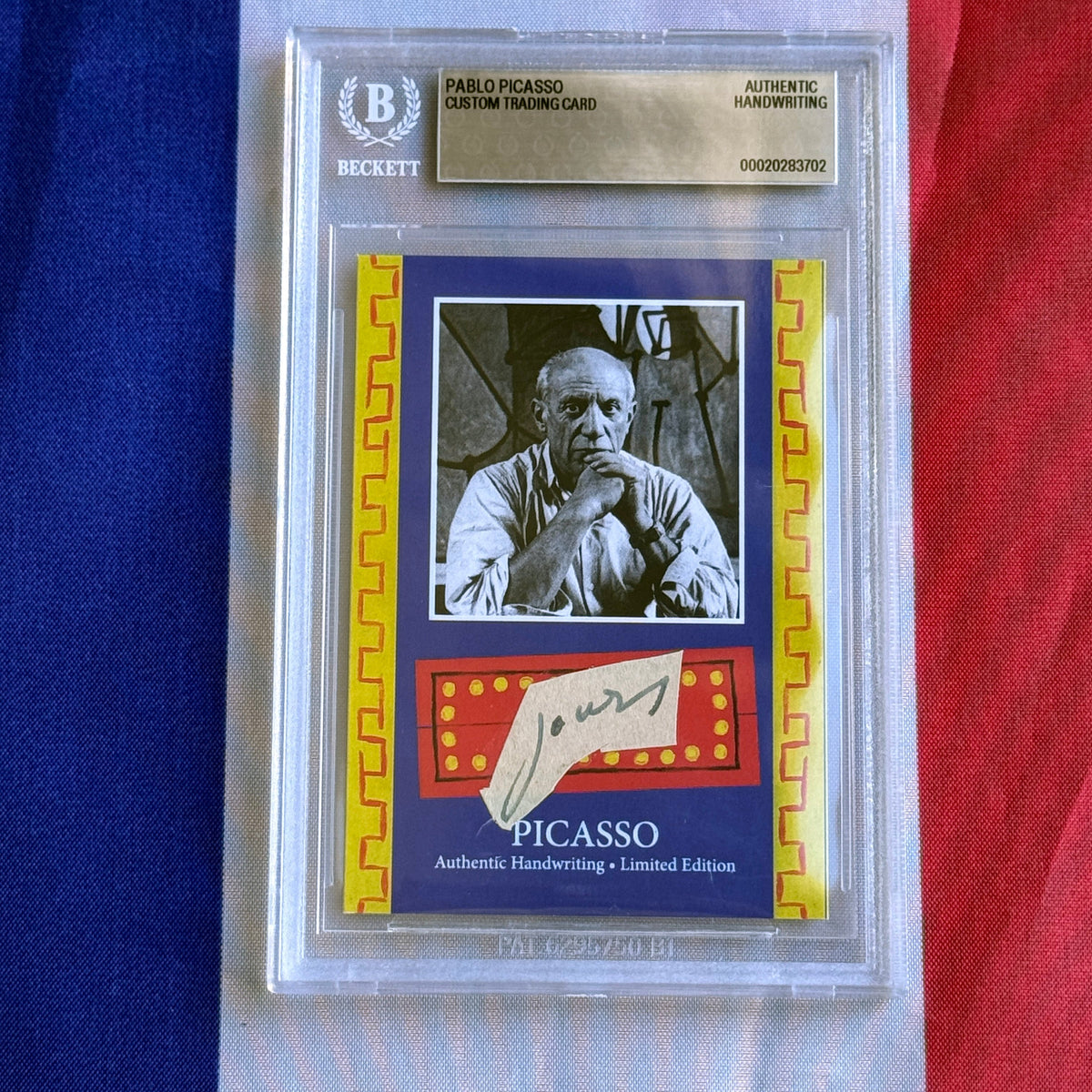 Front view of a Beckett-graded slab holding a blue card with a black-and-white portrait and a handwritten "Jours" scrap.