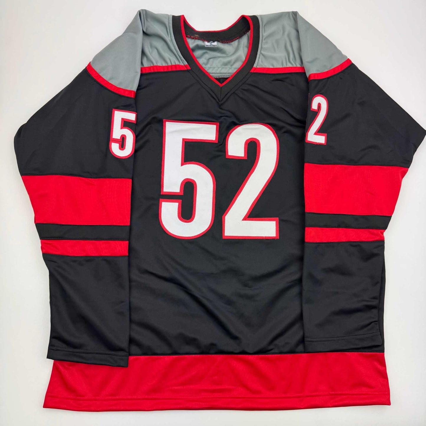 Black and red striped hockey jersey with number 52 in white lettering, displayed flat against white background.