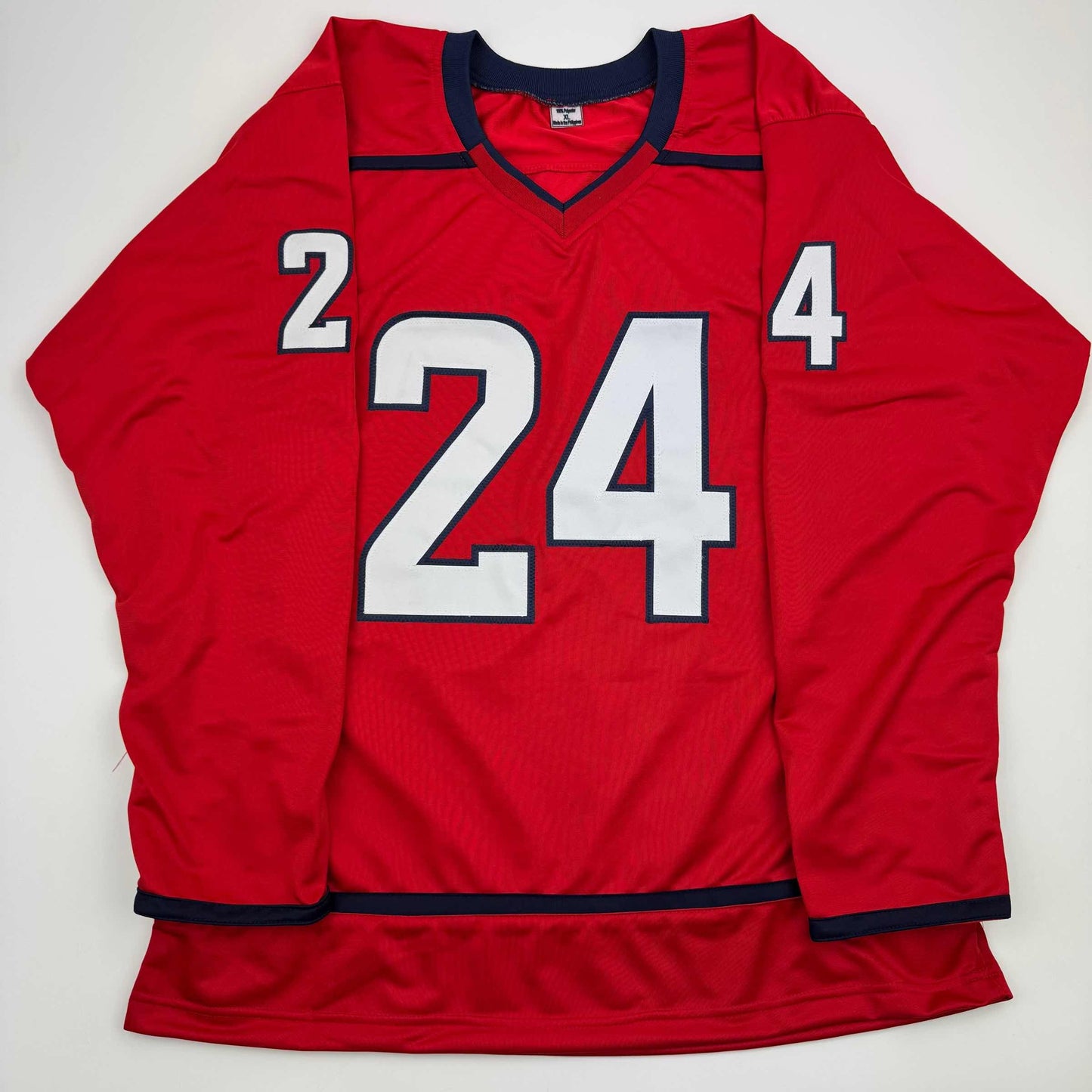 Red hockey jersey with white and navy number 24 displayed flat against white background, front view.