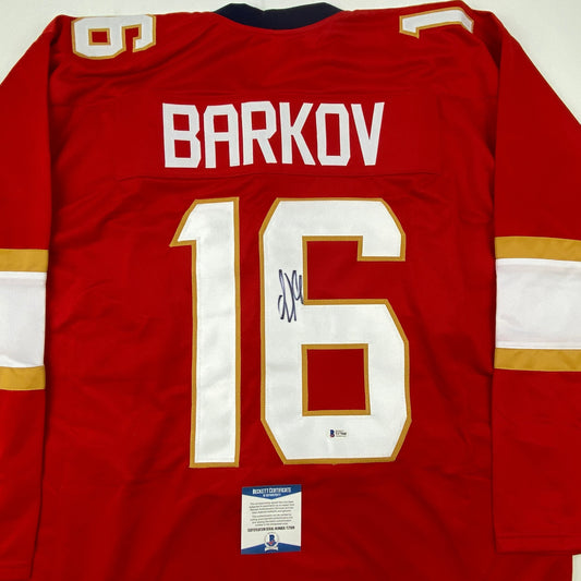 Red Florida hockey jersey with "BARKOV" and number "16" displayed on back, featuring white and gold trim, with Beckett authentication certificate visible at bottom.