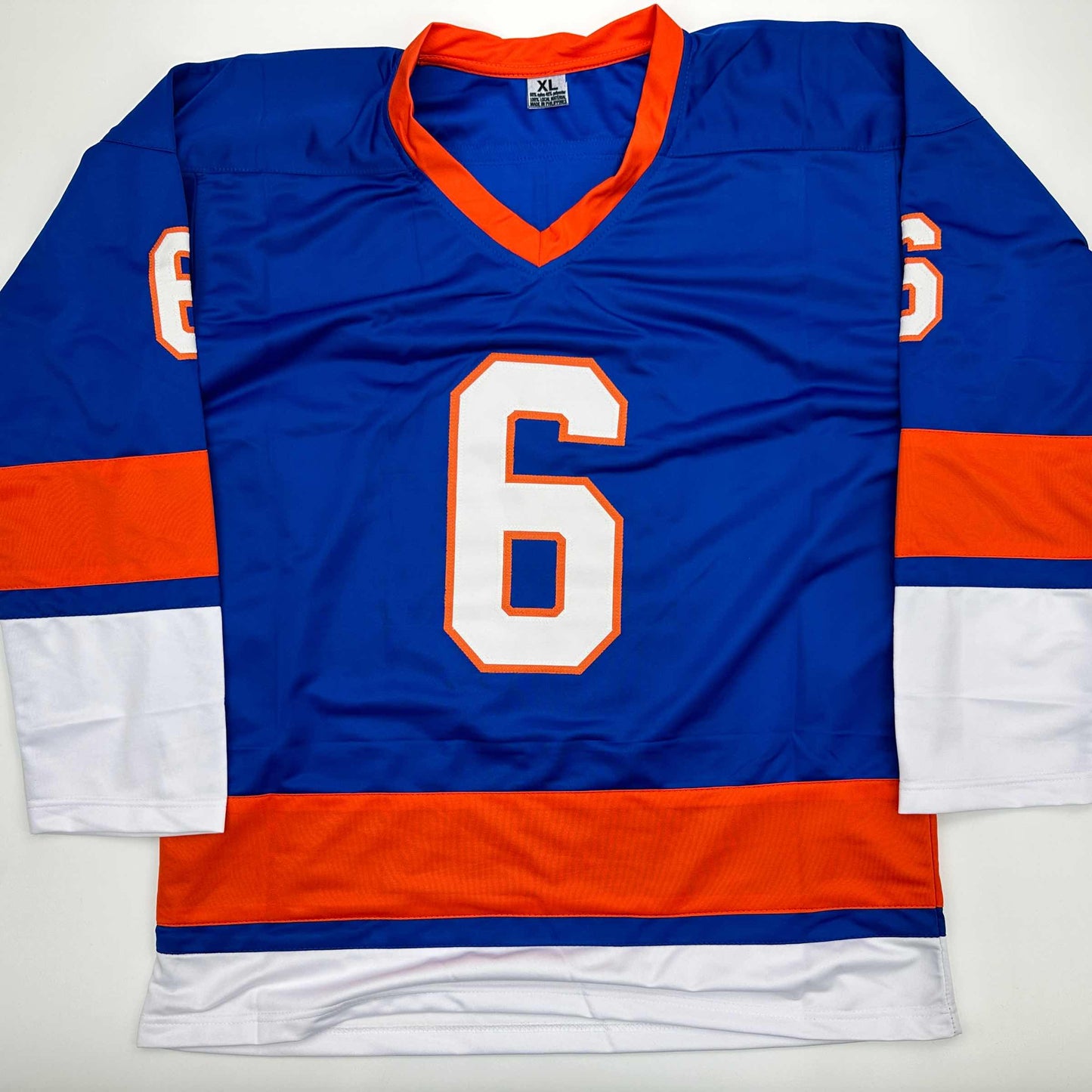 Blue and orange hockey jersey with number 6 displayed flat on white background, showing front view with v-neck collar and striped sleeves.