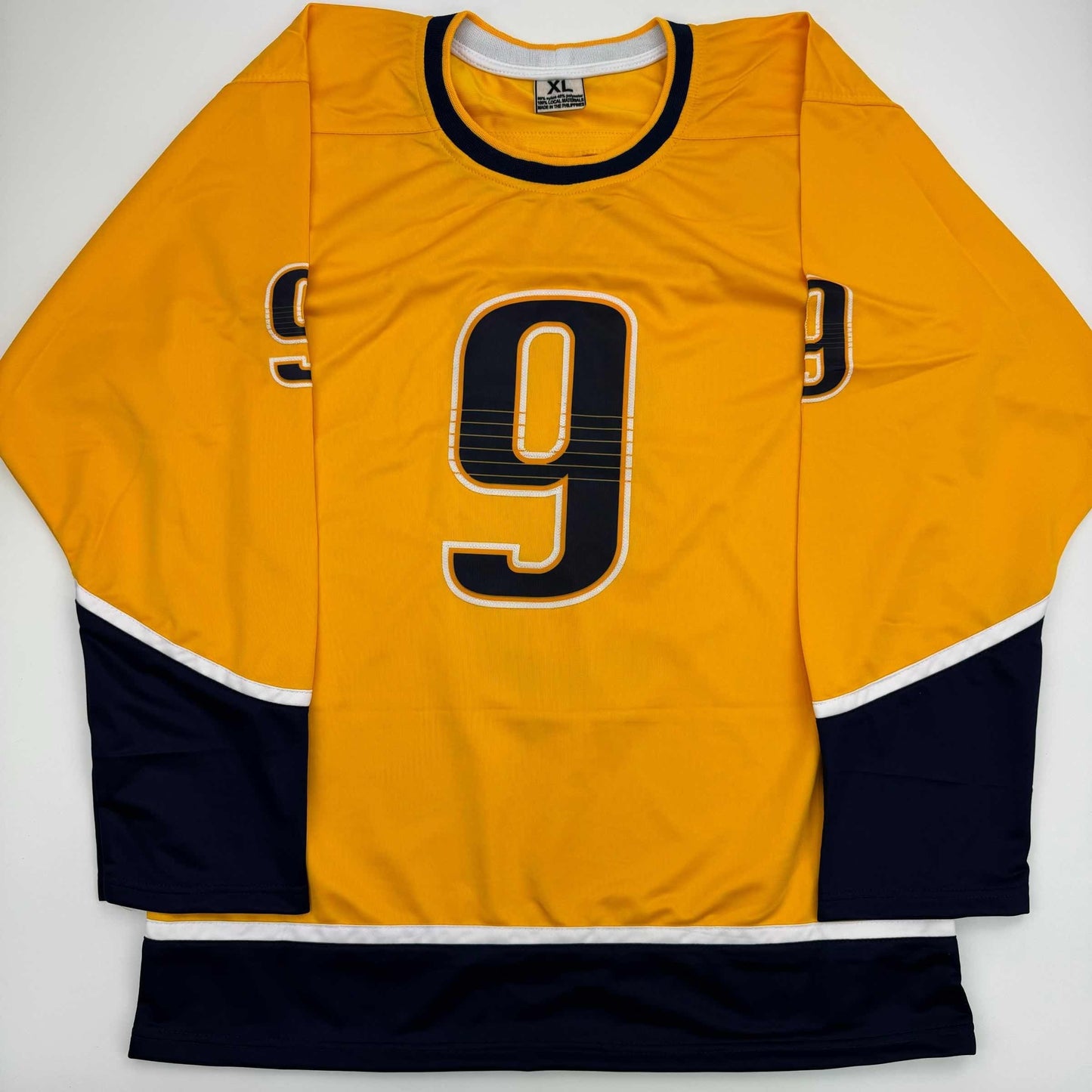 Yellow hockey jersey with number 9, black and white trim, displayed flat against white background.