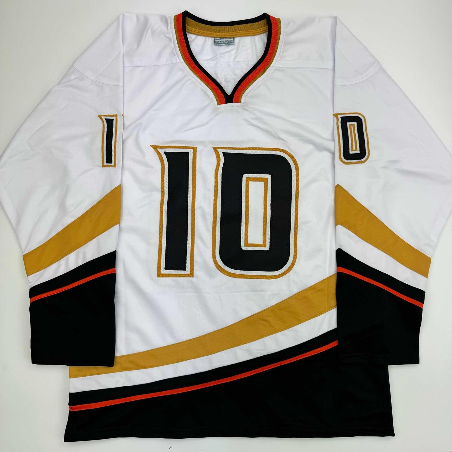 White hockey jersey number 10 with black and gold trim, displayed flat on gray background.