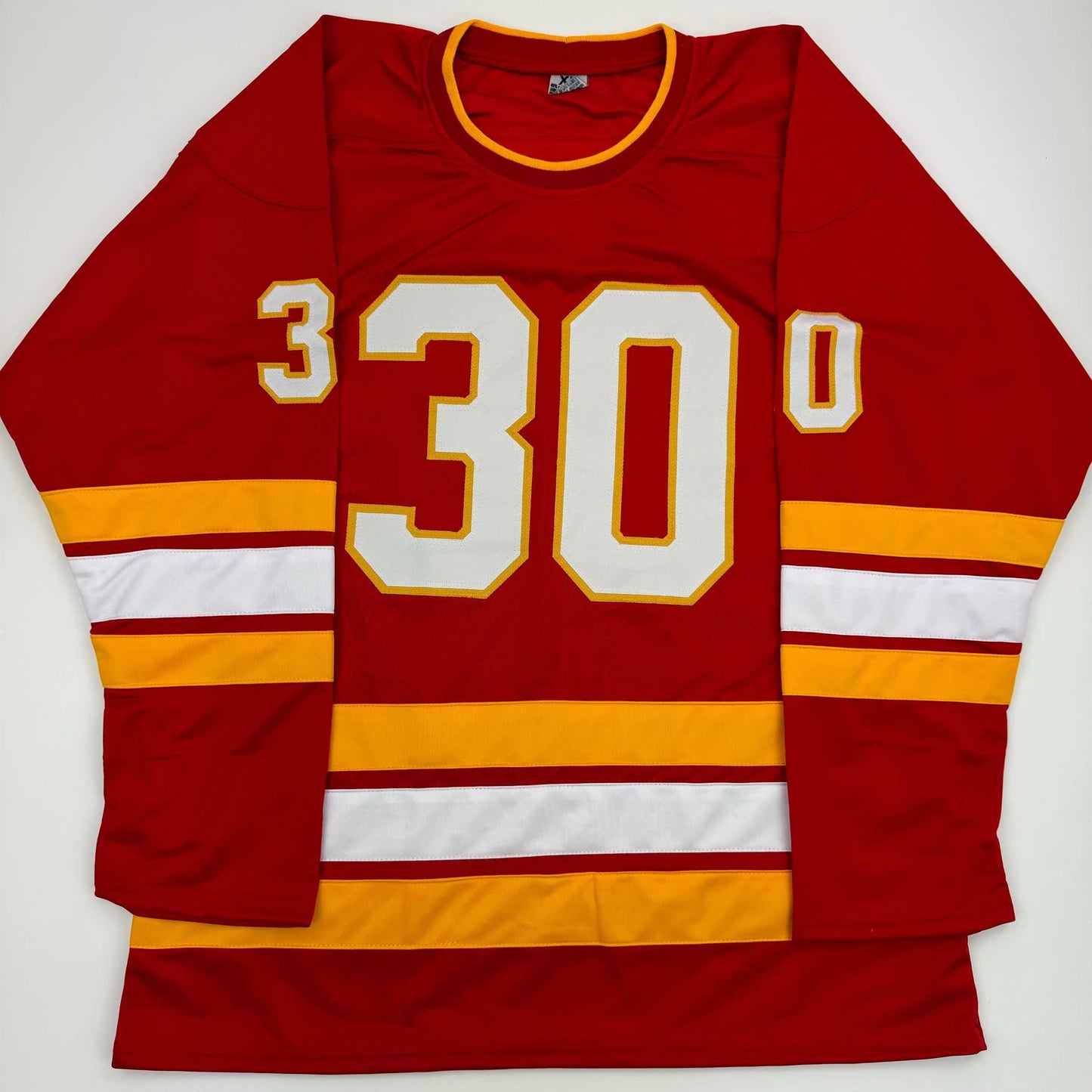 Red hockey jersey with white and gold number 30 displayed flat against white background, showing front view with horizontal striped sleeves.